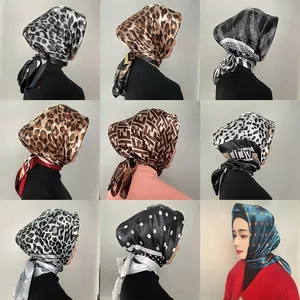 Detail of 90cm satin square scarves featuring various cashew and geometric prints