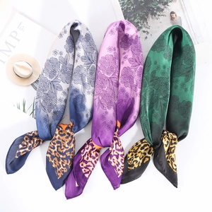 Detailed flat lay of three gradient leopard print scarves with floral textures
