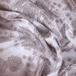 Detailed macro view of leopard floral print fabric with silky texture and soft drape