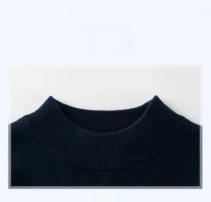 Detailed view of the navy blue ribbed crew neckline on this knitted children sweater