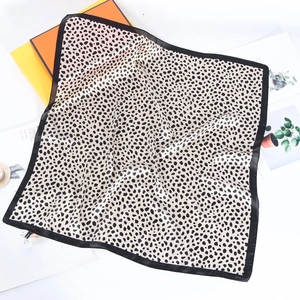Satin leopard print square neck scarf with black borders on luxury orange background