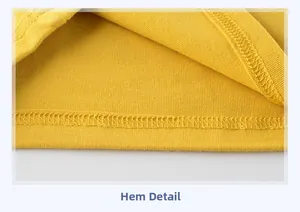 Detail view of the yellow cotton t-shirt hem showing clean overlock stitching quality