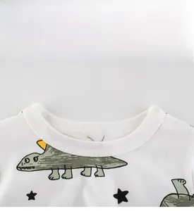 Close-up of crew neck ribbed collar on white cotton toddler t-shirt with dinosaur print