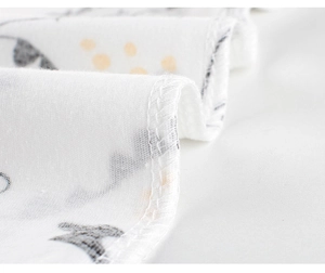 Macro detail of breathable white cotton fabric with yellow polka dots and fine stitching