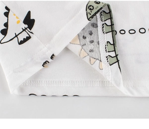 Close-up of kids dinosaur t-shirt hem showing high-quality stitching and cotton knit fabric