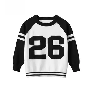 Close-up of kids black and white knit sweater with 26 number print and ribbed hem