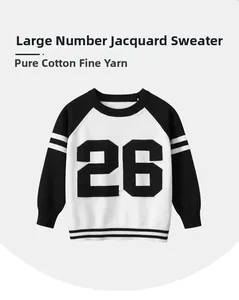 Detail of pure cotton kids knit sweater featuring black and white contrast raglan sleeves