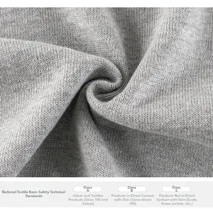 Close-up of grey knit fabric showing GB 18401 safety standards for baby clothing