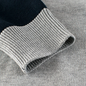 Kids navy and grey knit sweater showing detailed ribbed cuffs and soft cotton texture