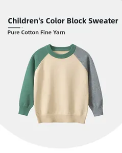 Detail of color-block knit sweater for boys featuring green and beige cotton texture