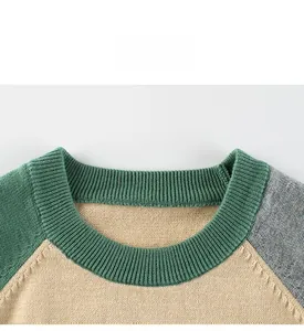 Detailed view of color-block knit sweater with green ribbed collar and beige body