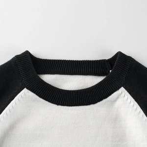 Classic kids black and white contrast knit sweater with ribbed crew neck and raglan sleeves