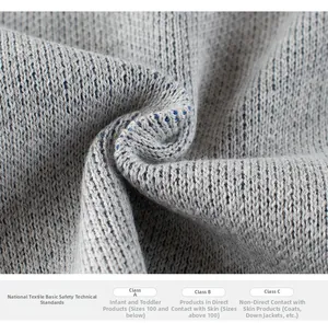 Detail of grey knitted fabric with vertical rib texture showing textile safety standards