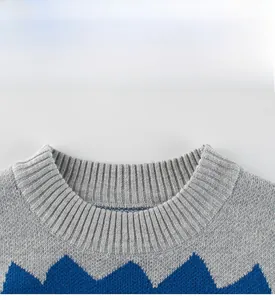 Detailed macro view of the knitted crew neck with navy and grey geometric wave patterns