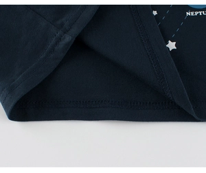 Detailed close-up of navy blue cotton fabric with white star print and double-stitched hem