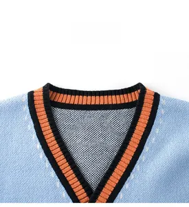Detail of the V-neck rib knit collar with orange and black stripes on a blue sweater vest