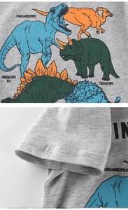 Detail of gray cotton kids T-shirt featuring dinosaur prints and double-stitched sleeve cuff