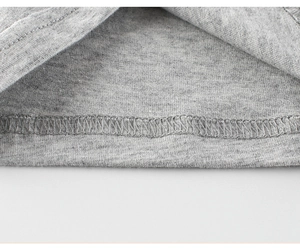 Close-up of double-needle stitching and overlock seams on grey cotton kid's t-shirt