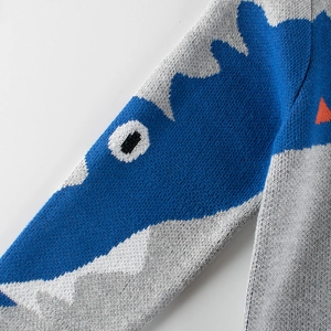 Kids grey knitted sweater featuring a blue cartoon dinosaur pattern and soft cotton texture