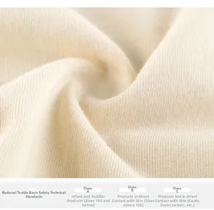 Close-up of soft off-white cotton fabric texture meeting Category A safety standards