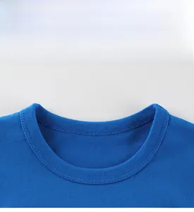 Close-up of double-needle neckline stitching on blue cotton kids excavator t-shirt