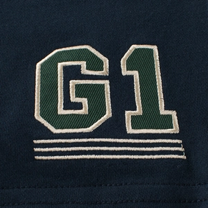 Dark blue boys shorts with green G1 embroidered patch in collegiate athletic style