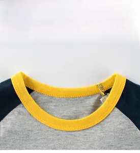 Detail of kid's raglan T-shirt showing yellow ribbed neckline and grey knit fabric