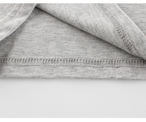 Macro shot of double-needle stitching on grey knit fabric for children's cotton tee