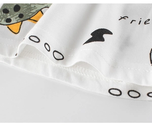 Detail view of cotton kids shorts featuring green dinosaur prints and durable double stitching