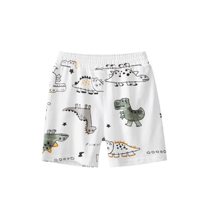 Cotton kids shorts with elastic waistband and colorful dinosaur pattern on white background