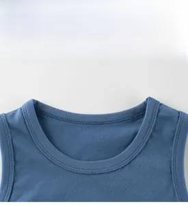Detail view of denim blue cotton knitted vest featuring a reinforced ribbed crew neckline