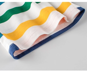Close-up of rainbow striped cotton fabric showing double-needle stitching and hem detail