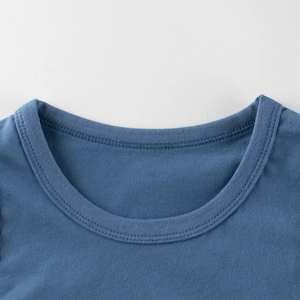 Close-up of blue cotton kids' round neck T-shirt showing detailed stitching and fabric texture