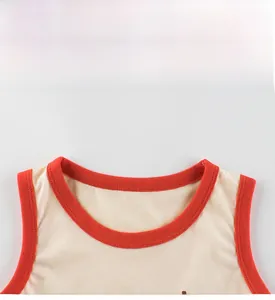Detail view of cotton sleeveless vest with red ribbed neckline and fine knit texture