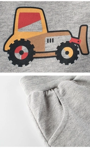 Detail of gray kids shorts featuring bulldozer print and elastic waistband sewing
