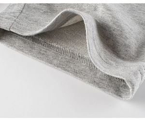 Macro shot of high-quality French Terry cotton fabric and neat stitching on grey shorts