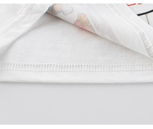 Detail of double-needle stitching on hem of white cotton toddler tank top