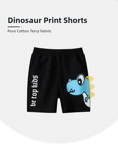 Détail du short en coton pour garçon avec imprimé dinosaure bleu et nageoires jaunes