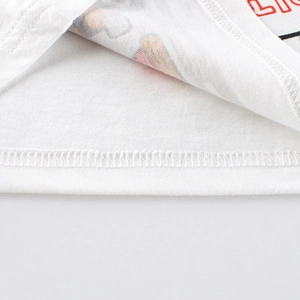 Close-up of white cotton boy's tank top featuring red LION print and neat stitching