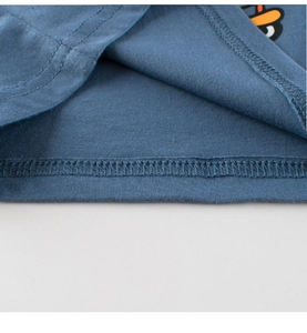 Close-up of the double-stitched hem and cotton fabric texture on blue kids tank top