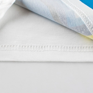 Close-up of white cotton children's t-shirt showing high-quality stitching and fabric