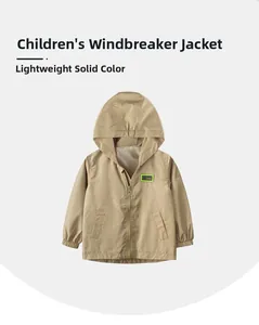Detail of kids light khaki hooded windbreaker with front zipper and chest patch