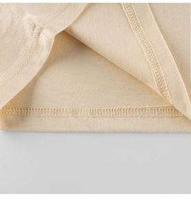 Detailed close-up of double-needle stitching on the hem of a kids cotton knit t-shirt