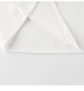 Close-up of double-stitched hem on kids white cotton t-shirt with clean craftsmanship