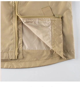 Macro detail of high-quality nylon zipper and stitching on beige spring jacket hem