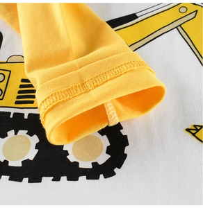 Detail of yellow ribbed cuff and cartoon excavator print on cotton long sleeve tee