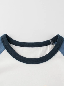 Kids long sleeve crew neck raglan t-shirt made of white and navy blue cotton fabric