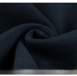 Detail of high-quality navy blue knitted fabric texture showing softness and thickness