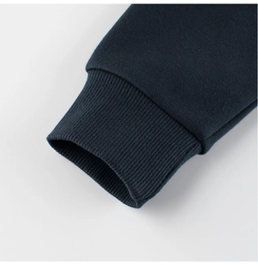Detail of ribbed knit cuffs on kids' navy dinosaur sweatshirt showing texture and quality