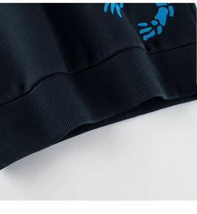 Detail of ribbed hem on kids dinosaur sweatshirt featuring bright blue bone print
